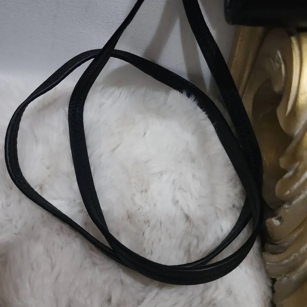 Coach Avery leather phone crossbody w/ a flap closure.